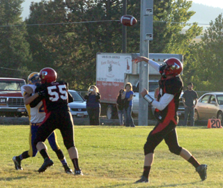 Jake Bruner throws a pass. Blocking for him is Bobby Hood.