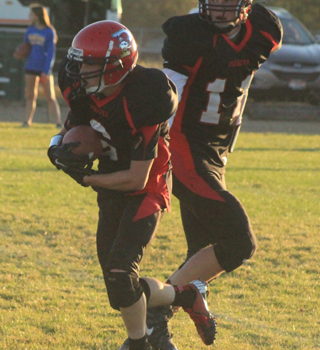 Luke Wemhoff runs with the ball after a handoff from quarterback Jake Bruner.