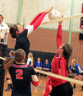 Shayla VonBargen stuffs a spike against St. John Endicott. No. 2 is Mykaela McWilliams.