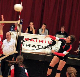 Shayla VonBargen scores on a right side hit against C.V. Also shown are Hailey Danly and Sarah Seubert.
