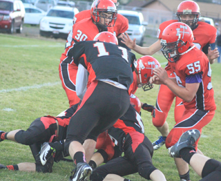 Prairie defenders gang up to tackle a Council runner. Making the tackle at left is Brandon Higgins and on the right is Brandon Anderson. Jake Bruner comes in to help finish off the play.