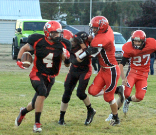 Brandon Higgins makes a block that springs Isaiah Shears, 4, for extra yards.