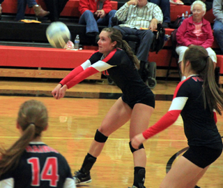 Krystin Uhlenkott makes a pass at Troy. Also shown are Sarah Seubert and Angela Wemhoff.
