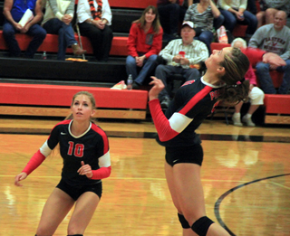 Krystin Uhlenkott goes for one of her many kills at Troy. Also shown is Chaye Uptmor.