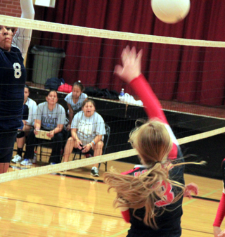 Leah Higgins picks up a kill against Lapwai as she sends the ball down the net to that wide open area to the blockers left.