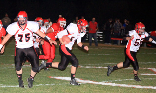 Philip Spencer, 75, and Bobby Hood, 55, look for somebody to block as Jake Bruner carries the ball for what turned out to be a 55 yard touchdown run.