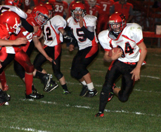 Jayce Huling carries the ball for the Pirates in the second half. Also shown are Thomas Schwartz, 42, and Caleb McWilliams, 15.