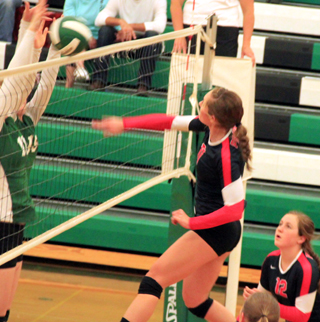 Krystin Uhlenkott scores a kill at Potlatch as Angela Wemhoff watches.