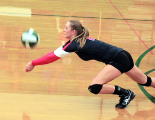 Mykaela McWilliams stretches forward to dig a serve at Potlatch.