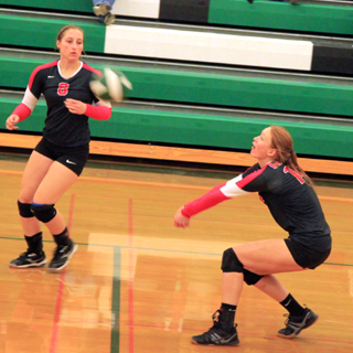 Sarah Seubert is about to make a pass against Potlatch to setter Hailey Danly, at left.