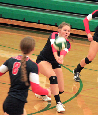 Sydney Bruner makes a pass in the Potlatch match. In the foreground is Hailey Danly.