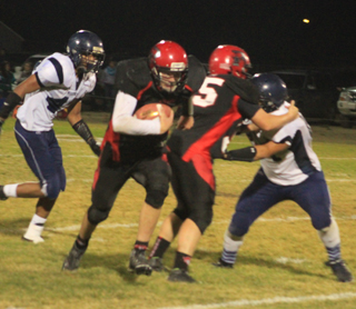 Bobby Hood blocks a Lapwai defender to help spring Jake Bruner, with ball, for a long touchdown run.