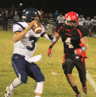 Prairie defenders harassed Lapwai passers all game long. Here Isaiah Shears closes in on Lapwai quarterback Courage Lone Bear.