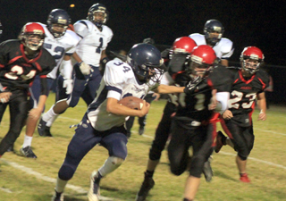 Jake Bruner closes in on a Lapwai ballcarrier. 24 is Daniel Mager and 23 is Calvin Hinkelman.