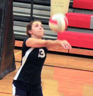 Rachel Waters sets the ball at the C.V. match.