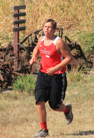 Ryan Glimp passes some old farm machinery as he nears the finish.