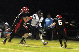 Luke Wemhoff, 6, is about to block Lapwais #3 so that Isaiah Shears, left, can finish off a 59 yard touchdown play. Behind Shears is Devin Bruegeman who also helped with downfield blocking.