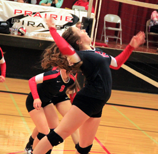Angela Wemhoff goes up strong against Troy. Hidden behind Wemhoff is Hailey Danly.