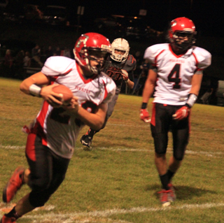 Calvin Hinkelman heads for a touchdown after taking a lateral from Isaiah Shears, right, near the end of the first half.