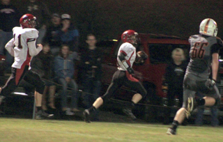 Brandon Higgins races down the sideline after recovering a fumble forced by Jake Bruner, left. Higgins was caught at the 5 but Prairie scored soon after.
