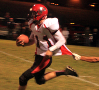 Jake Bruner runs with the ball and if not for the handful of jersey could have gone for a touchdown.