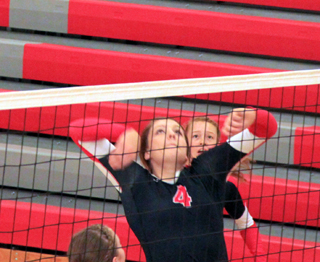 Shayla VonBargen winds up for a kill against Potlatch. In the back is Sarah Seubert.