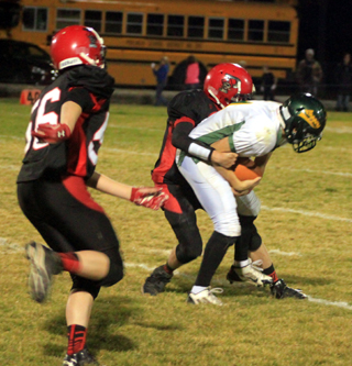 Daniel Mager is about to tackle a Potlatch ballcarrier as Justin Schumacher moves in to help.