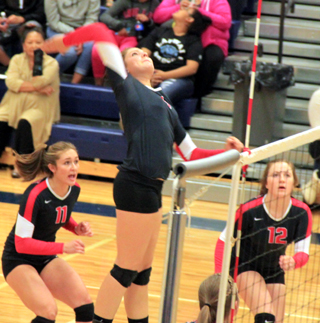 Shayla VonBargen goes up for a spike at Lapwai as Krystin Uhlenkott and Angela Wemhoff look on.
