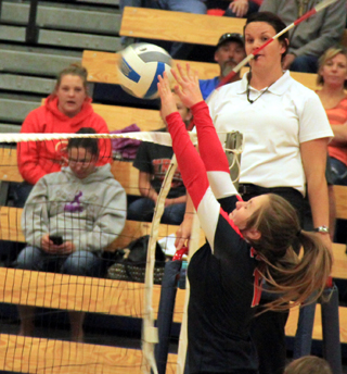 Angela Wemhoff blocks a Troy spike as it comes off the top of the net.