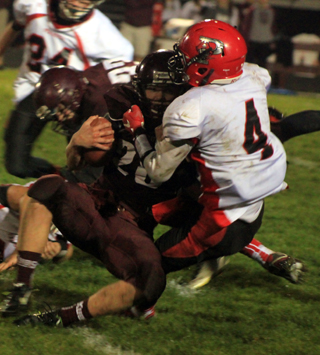 Isaiah Shears tackles Kamiah’s quarterback for a loss. Also shown is Daniel Mager.