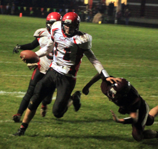 Jake Bruner wards off the last Kamiah defender with a chance to stop him from scoring a touchdown. Behind Bruner is Terran Peery.