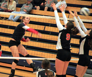 Krystin Uhlenkott slams the ball past Troys blockers.