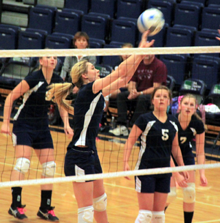 Summits Lauren Stubbers  pushes the ball over the net against Deary. Also shown from left are Ally Sonnen, Taylor Lustig and Lucy Osborne.