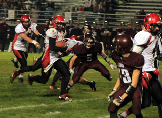 Terran Peery carries the ball on his way to Prairie’s first touchdown of the game. It was actually the second time he would cross the goalline but the first time that it counted. Making blocks from left are Philip Spencer, Devin Bruegeman, behind Peery, and Isaiah Shears.