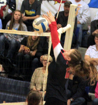 Angela Wemhoff blocks at the net against Genesee in the semifinal.