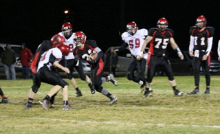 Brandon Anderson is about to get past a Wallace defender being blocked by an unidentified Pirate for a long touchdown run. #75 is Philip Spencer and #11 is Jake Bruner. Photo by Kellie Bruner.
