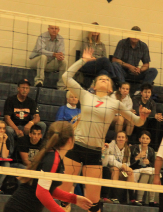 Chaye Uptmor winds up for a back row kill against Butte County. In the foreground is Angela Wemhoff.