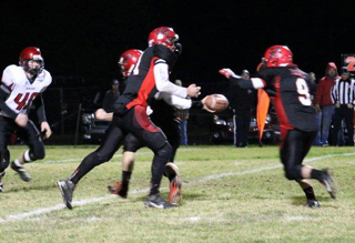 Jake Bruner is about to hand off to Terran Peery. Peery gained 100 yards rushing in the game. Photo by Kellie Bruner.