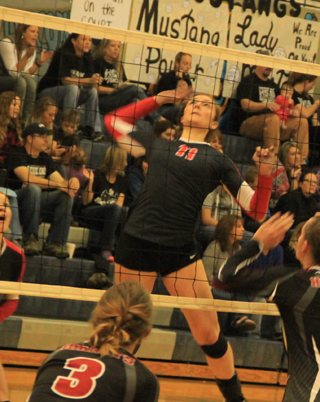 Krystin Uhlenkott winds up for a spike against Oakley.