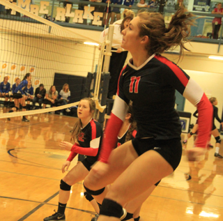 Krystin Uhlenkott after slamming a spike against Oakley. Also shown is Angela Wemhoff.