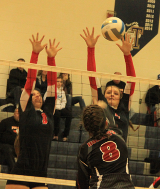 Shayla VonBargen appears to get a block against Oakley as she and Hailey Danly put up a wall.