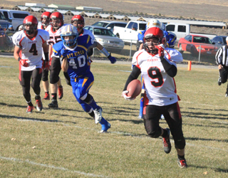 Terran Peery had a big day running the ball and picked up 51 yards on this play. Shown at left are Isaiah Shears and Bobby Hood.