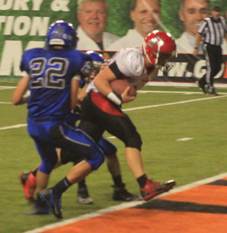Calvin Hinkelman bulls his way between 2 defenders into the end zone for a touchdown.