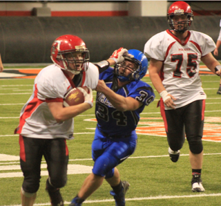 Devin Bruegeman stiffarms a Valley defender after catching a pass. Also shown is Philip Spencer.