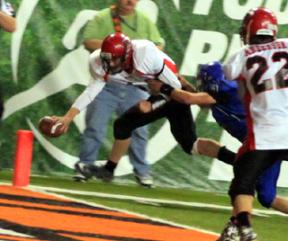 Jake Bruner reaches the ball towards the pylon on a 2-pt. conversion as Brandon Anderson watches.
