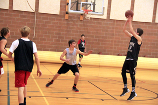 Seth Chaffee puts up a shot during a drill at Mondays varsity basketball practice. Also shown from left are Calvin Hinkelman, Tyson Schlader, Brandon Anderson and in the background Luke Wemhoff.