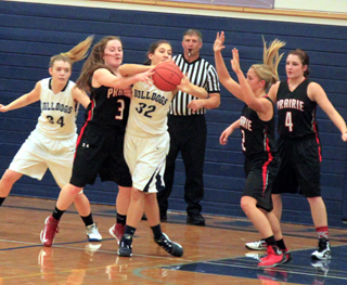 In the dark jerseys from left Angela Wemhoff, Kylie Tidwell and Shayla VonBargen play defense at Grangeville.