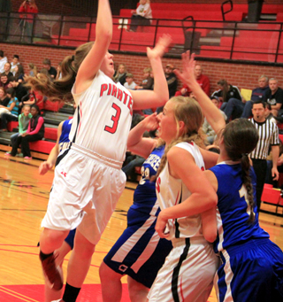 Angela Wemhoff shoots a jump hook against Genesee as Talyss Lustig wards off a defender.