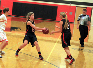 Chaye Uptmor hands off to Kylie Tidwell at Troy as part of Prairies 3-guard weave they run across the perimeter. If the referee looks familiar, yes, thats Shawn Kaschmitter, a PHS grad.