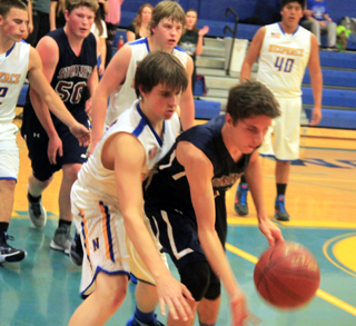 Summits Dean Stubbers goes after a loose ball at Nezperce. #50 in back is Chris Osborne.